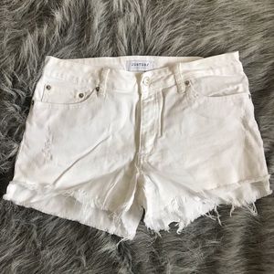 White denim shorts with frayed bottoms